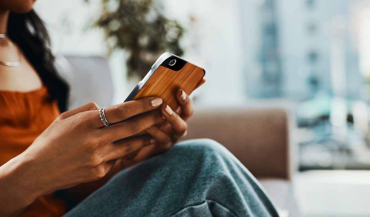 Cropped shot of a woman using a smartphone.