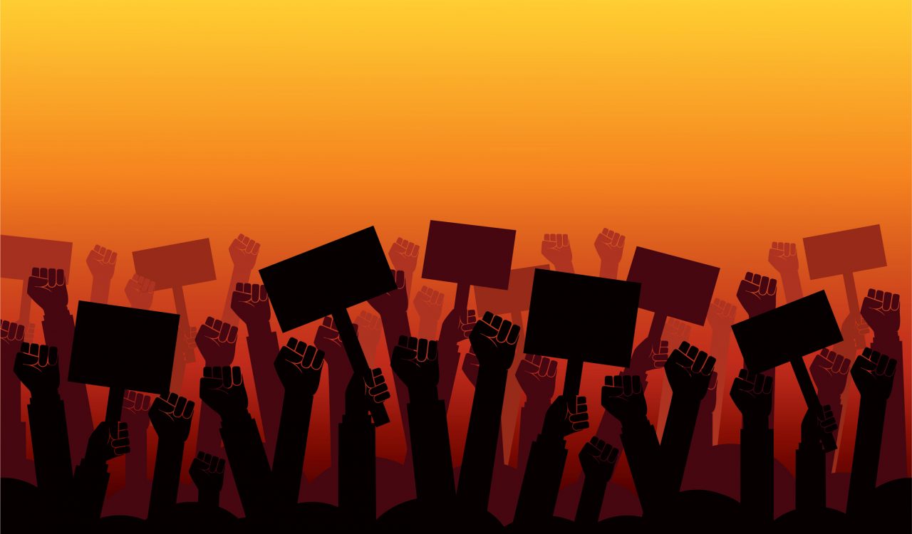 An illustration of hands holding protest signs against a graded orange backdrop.