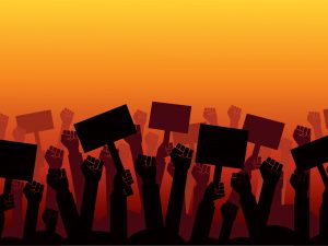 An illustration of hands holding protest signs against a graded orange backdrop.