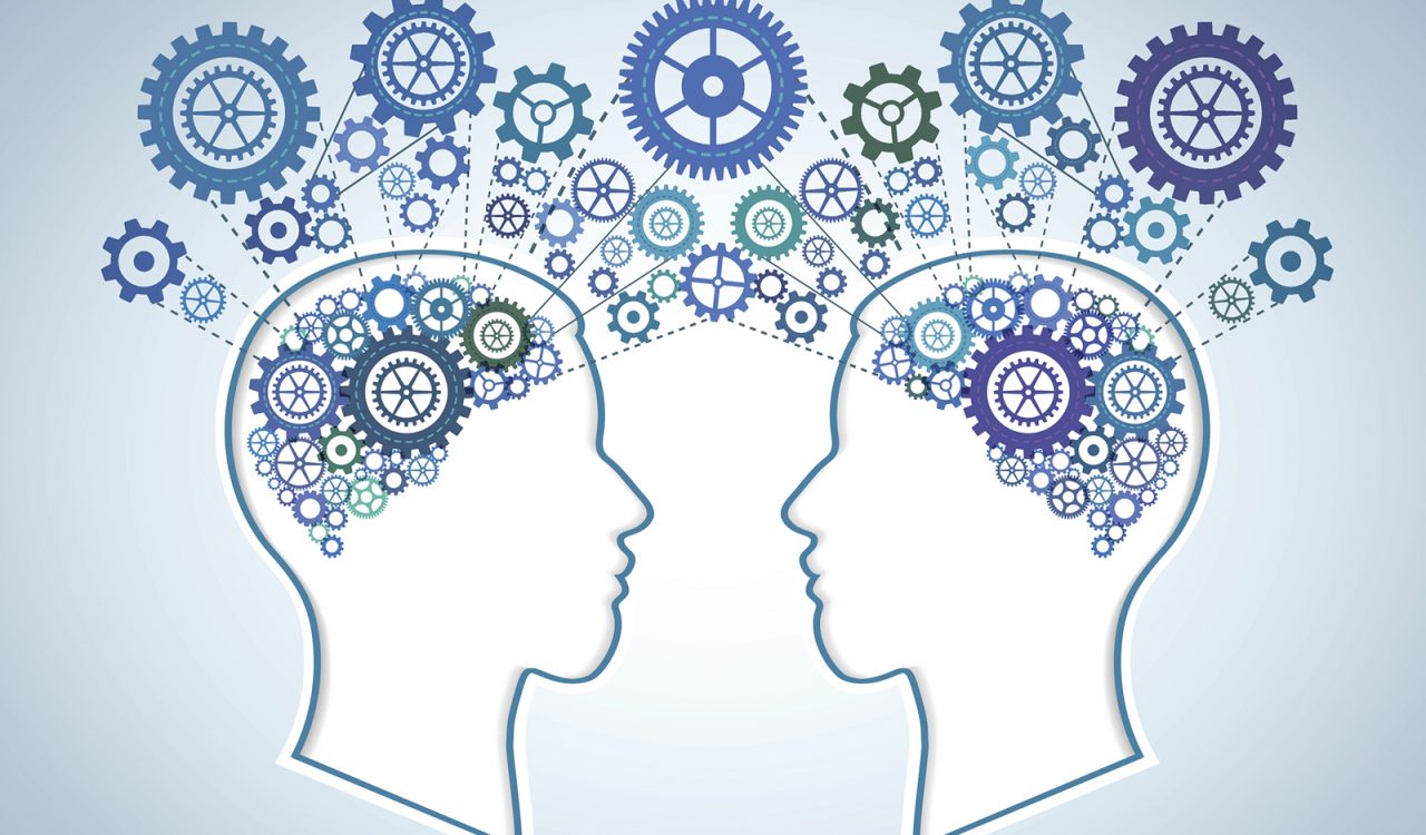 An illustration of two heads facing each other, with colourful cogs inside where the brain should be. The cogs leave each head and connect with each other on the outside.