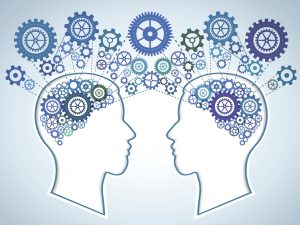 An illustration of two heads facing each other, with colourful cogs inside where the brain should be. The cogs leave each head and connect with each other on the outside.