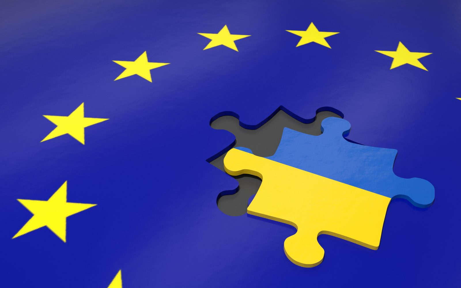A puzzle piece marked with the blue and yellow Ukraine national flag sits out of place on a graphic of the European Union flag, a circle of yellow stars on a dark blue ground.