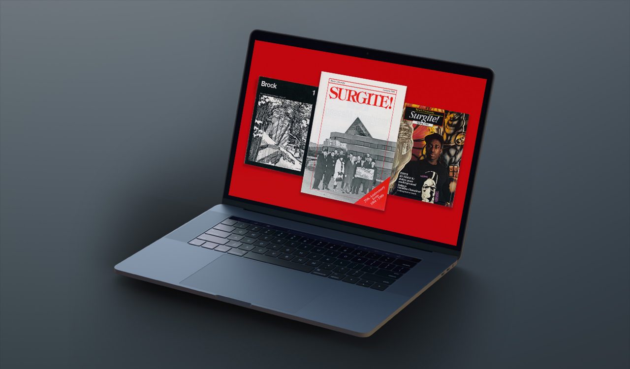 A digital illustration of a grey laptop on grey background shows three examples of old copies of Surgite magazine on its screen: a black and white cover with ‘Brock’ written top left and ‘1’ top right, with a hand-illustrated image of a wooden building surrounded by trees; a cover with red letters that spell out ‘SURGITE!’ and a black and white photo with a group of people holding an artist rending of a building; and a cover with ‘Surgite!’ written in white cursive font and a head and shoulders photo of a student-athlete with basketball imagery in the background.