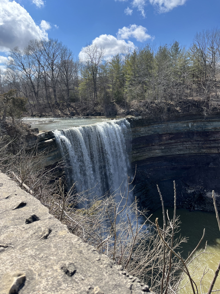Water falls over curved rock at Ball’s Falls