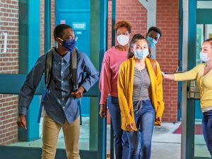 Youth wearing medical masks in a school.
