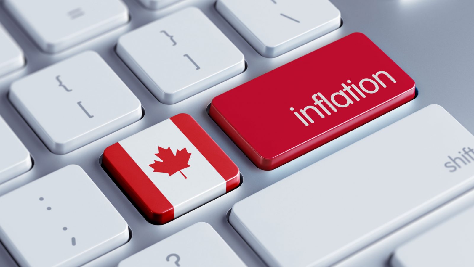 A closeup of a computer keyboard with the quotation key replaced with a Canadian flag and the return key replaced with a red button that reads ‘inflation.'