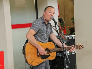 A person plays guitar while singing