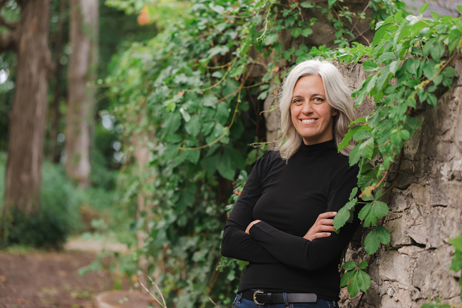 Rachel Rensink-Hoff, leaning against an ivy-covered wall.