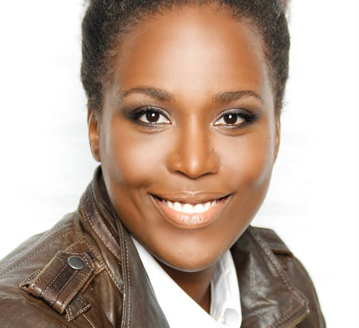 A portrait photo of a smiling woman in a brown leather jacket and white shirt.