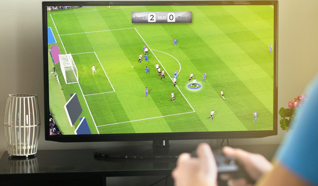 A tv screen displays virtual soccer players in the midst of a soccer game.