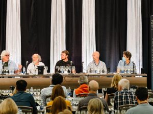 A group panelists with flights of Chardonnay discuss cool climate winemaking.