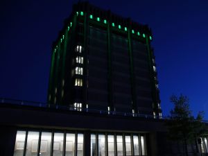 Brock University’s Arthur Schmon Tower lit in green LED lights.