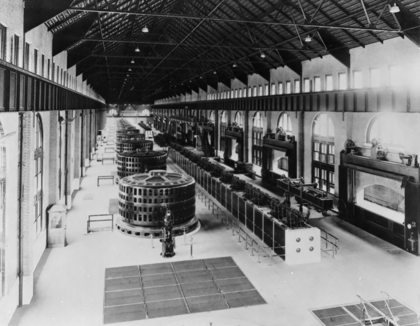 A black and white photo of power plant generators.