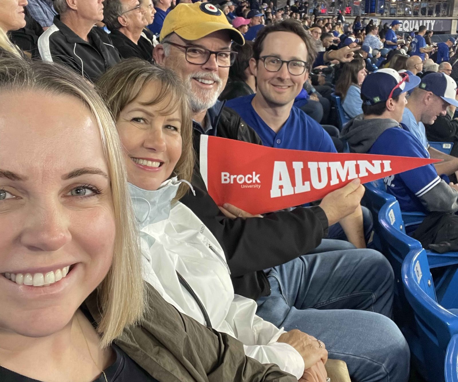 Brock Alumni Association President, Allie Hughes with family and fellow alumni at the Brock Alumni Blue Jays Game in Toronto.