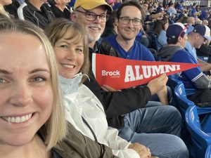 Brock Alumni Association President, Allie Hughes with family and fellow alumni at the Brock Alumni Blue Jays Game in Toronto.