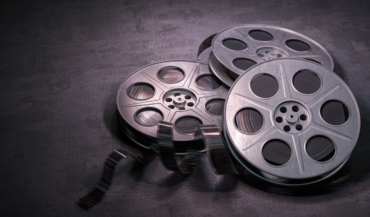 Three film reels on a black background.