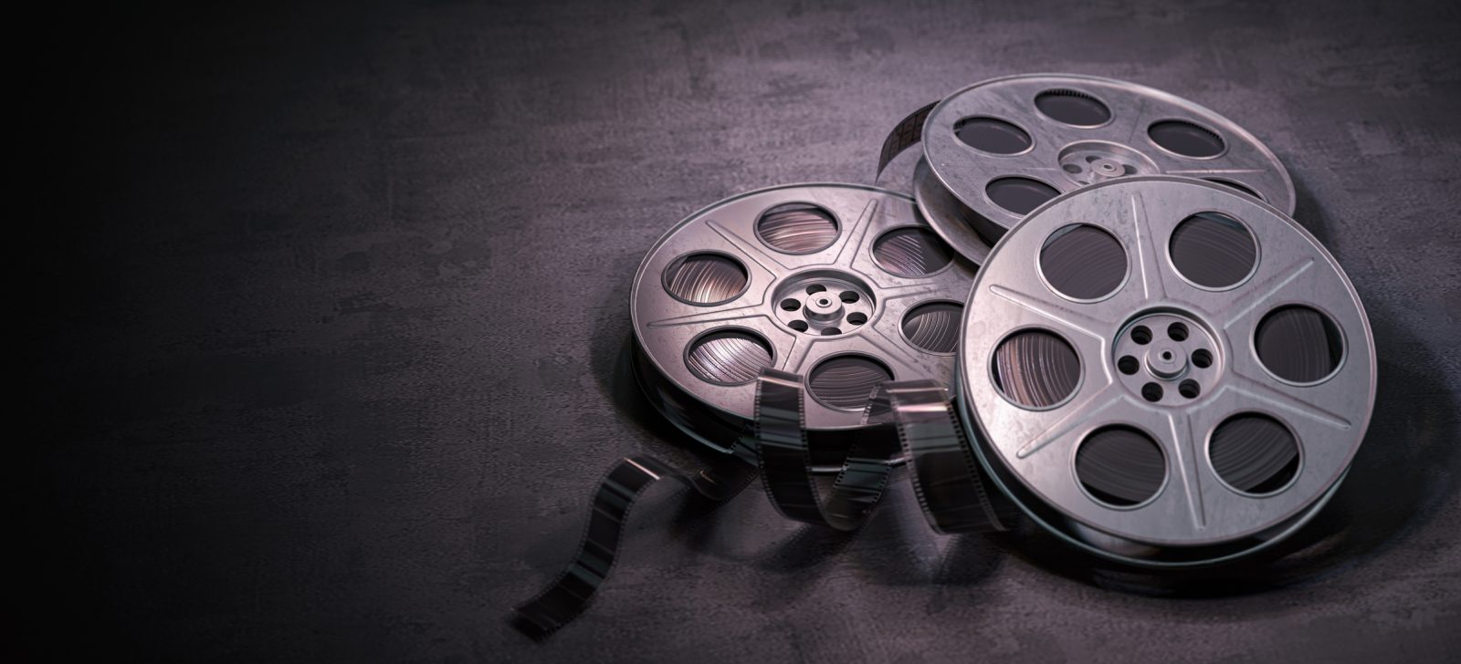 Three film reels on a black background.
