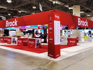 A Brock University-branded booth stands in a large convention centre.