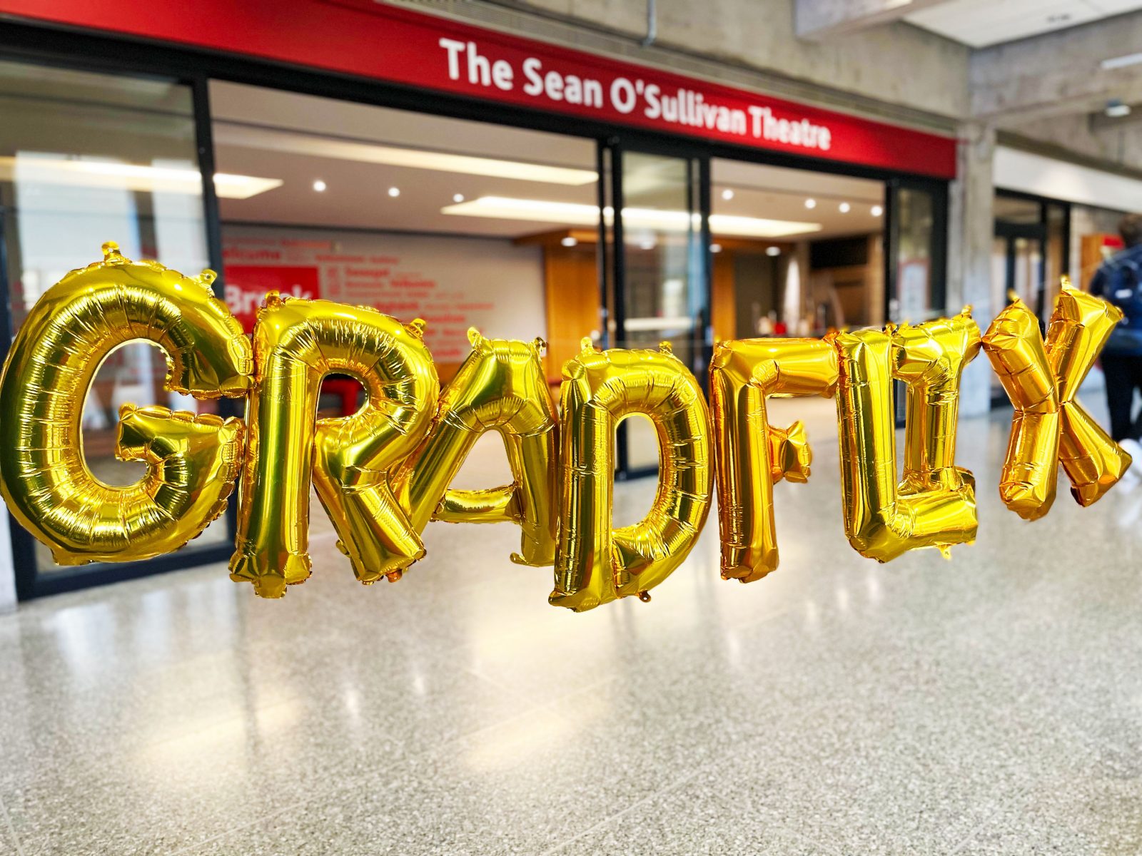 Gold GRADFlix balloons in front of Sean O’Sullivan theatre on Brock’s main campus.