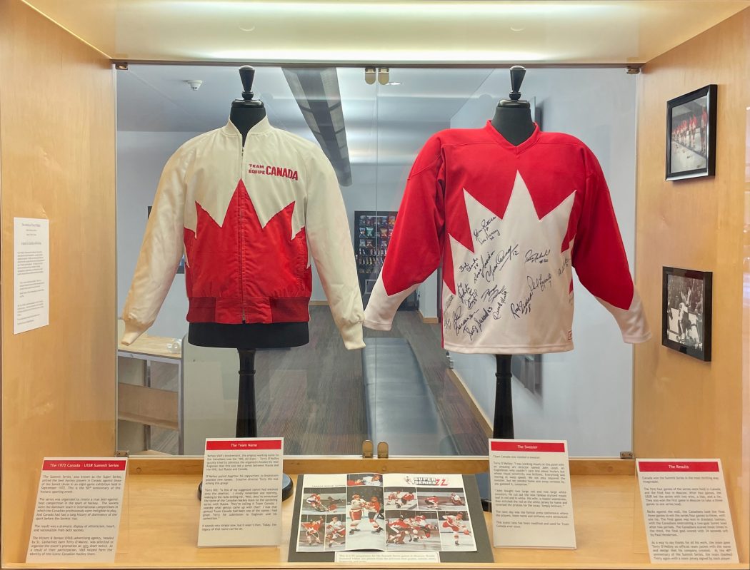 A display case with a team jacket and shirt.