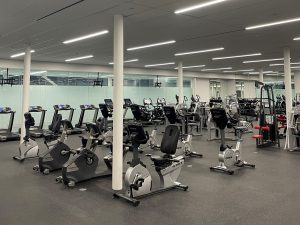 Bfit exercise machines are arranged in an open concept space.