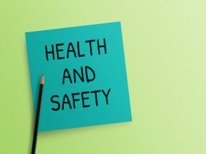 A green sticky note that reads ”Health and Safety”