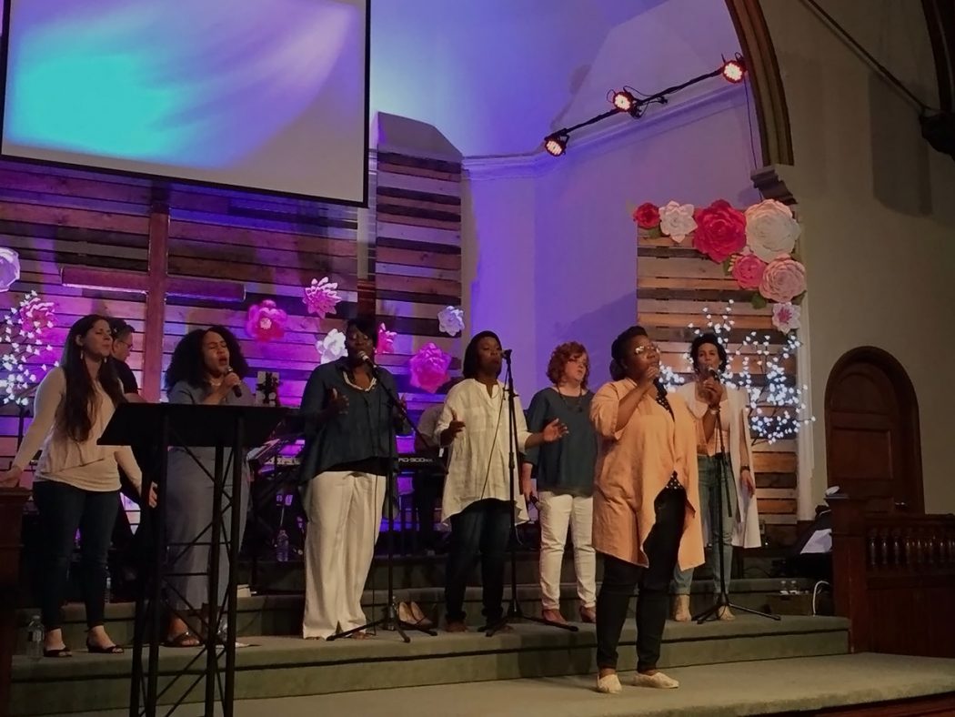 Tabitha Lewis sings in a church with six other singers.
