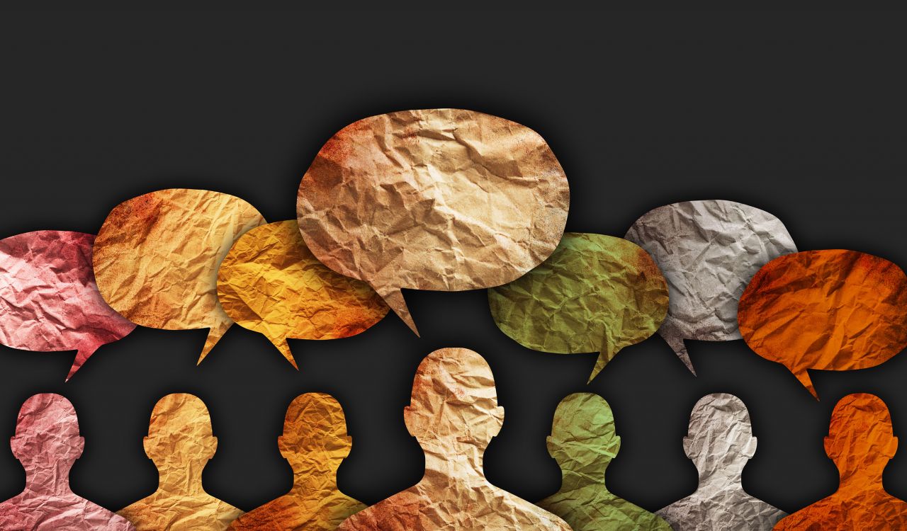 An illustration of several silhouettes of people with conversation bubbles above their heads, in a variety of colours.