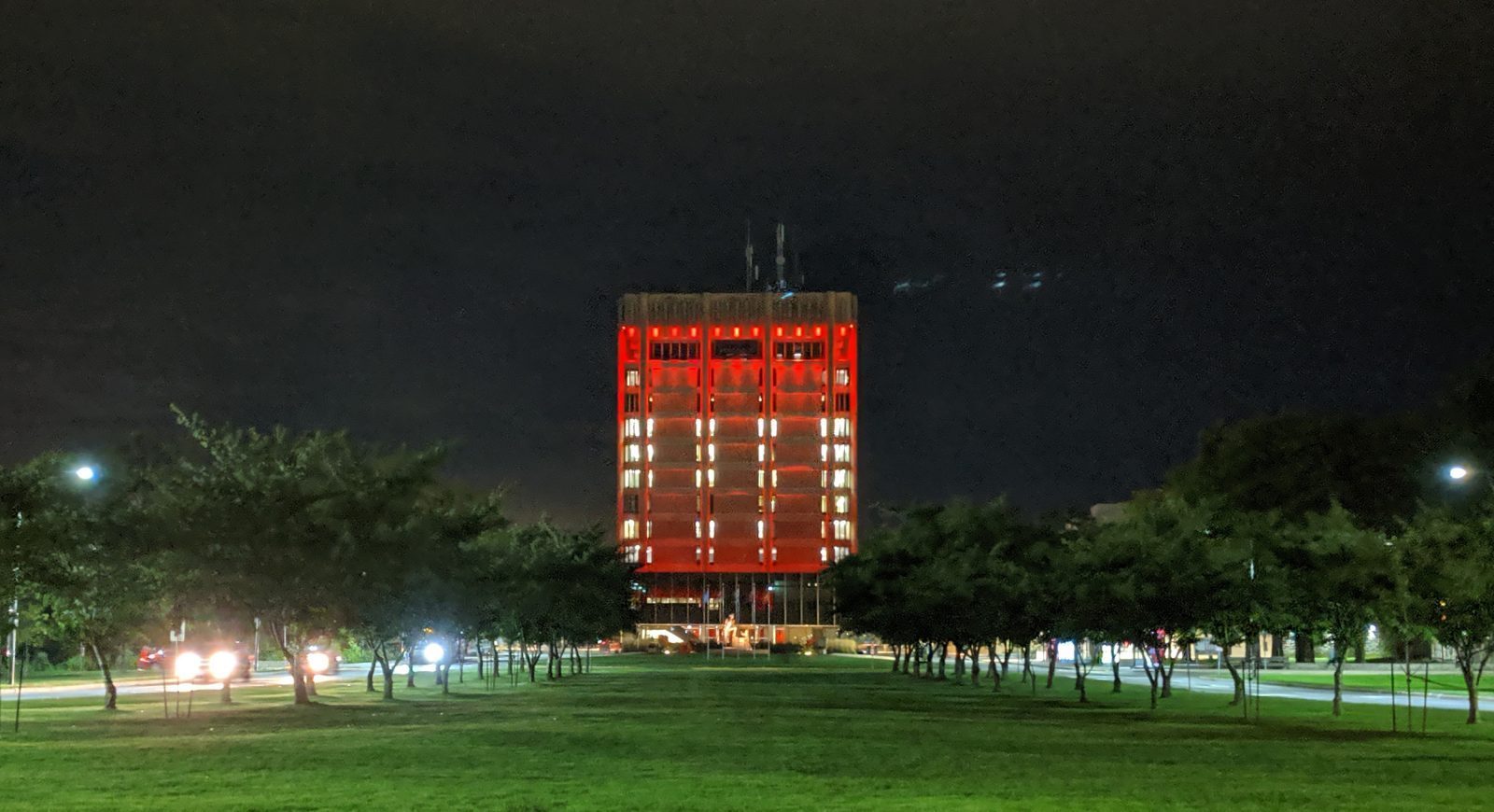 Brock's Schmon Tower illuminated in red light against a dark night sky.