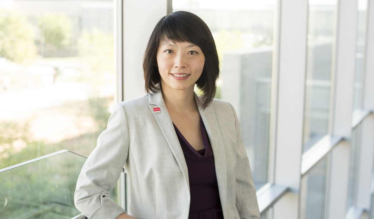 A portrait of Shawna Chen in front of windows.