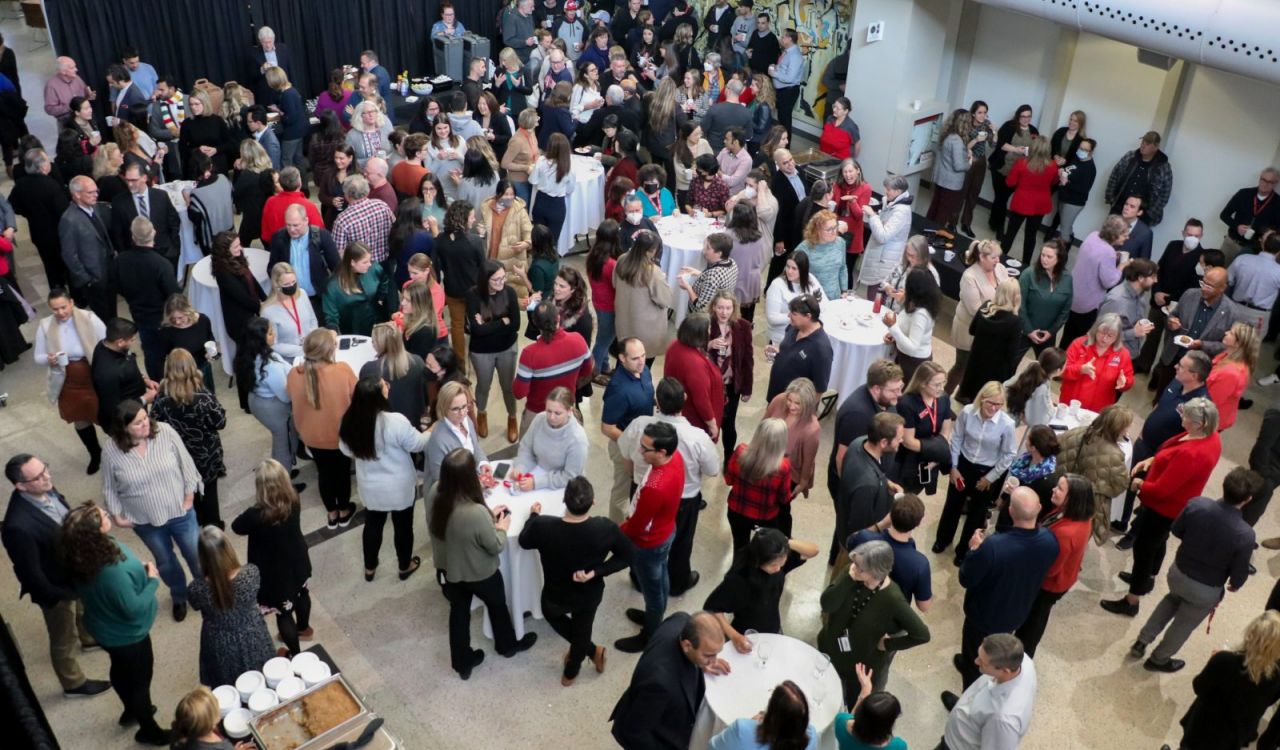 A large room filled with people mingling.