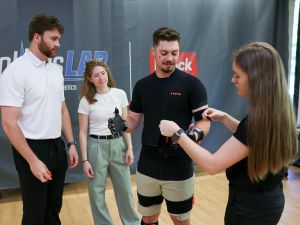 Three Brock University graduate students apply 3D motion capture equipment to their fellow student.