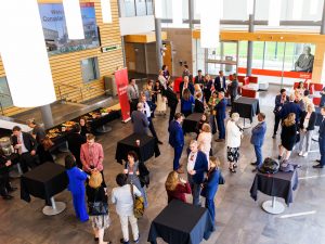 A group of people mingle at a reception at Brock University.