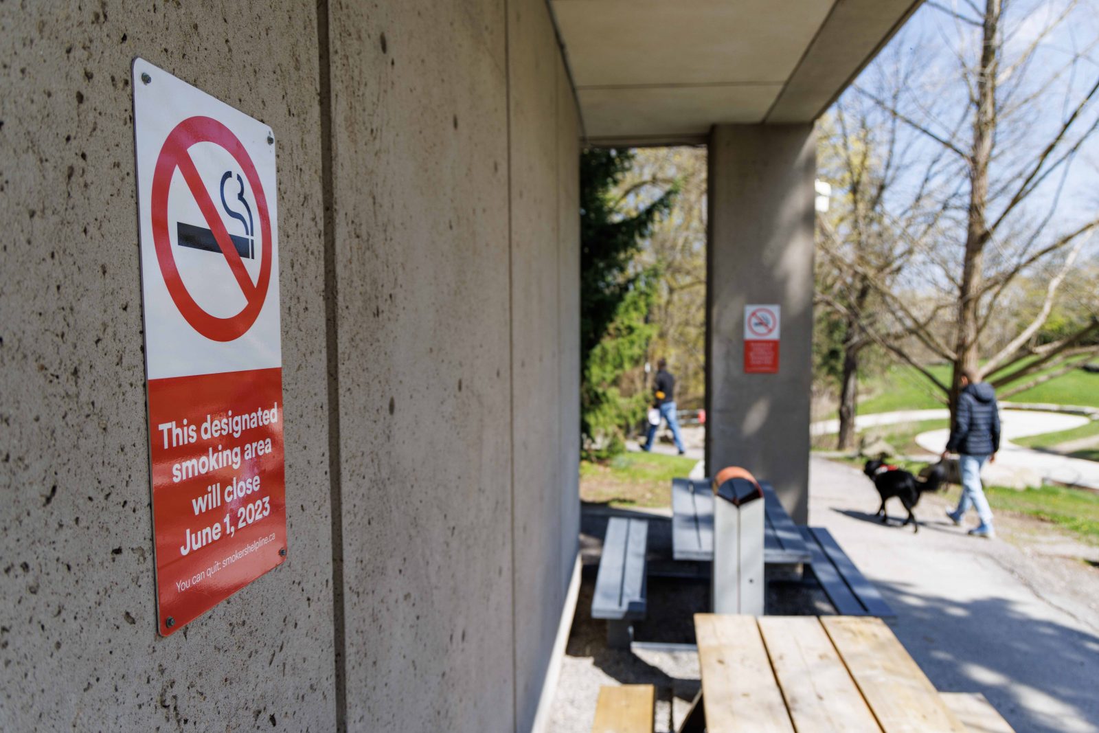 A no smoking sign with the text, “This designated smoking area will close June 1, 2023, is posted on a building.