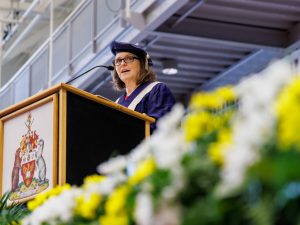 Lesley Rigg, Brock University's President and Vice-Chancellor, speaks behind a podium during a Convocation ceremony.
