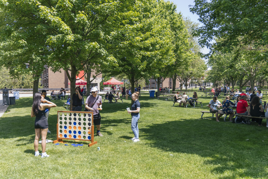 People playing lawn games at a barbecue in Brock University's Jubilee Court.