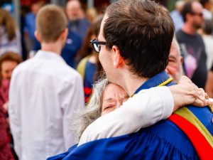 A Brock graduate hugs a loved one outside after Convocation.