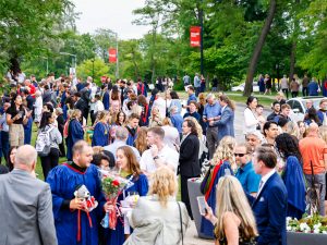 A crowd of family and friends celebrate outside after Brock University's Convocation.