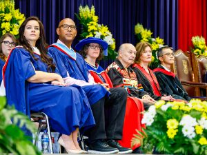 Faculty members and guests sit on the stage at Brock University's Convocation ceremony.