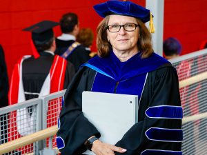 Lesley Rigg, Brock University's President and Vice-Chancellor, waits to enter a Convocation ceremony wearing academic regalia.