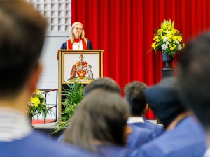 A woman speaks at a podium during Brock University's Convocation ceremony.