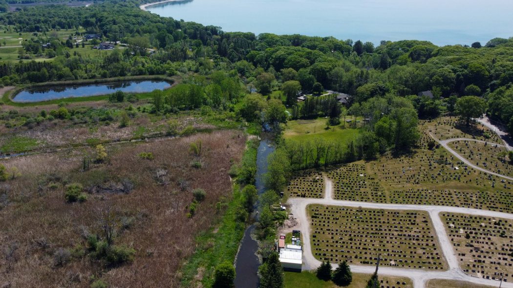 An aerial view of an open portion of the Wignell Drain running towards the shoreline of Lake Erie at Lorraine Bay.
