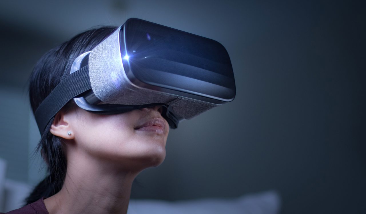 a person wearing a virtual reality headset looks up.