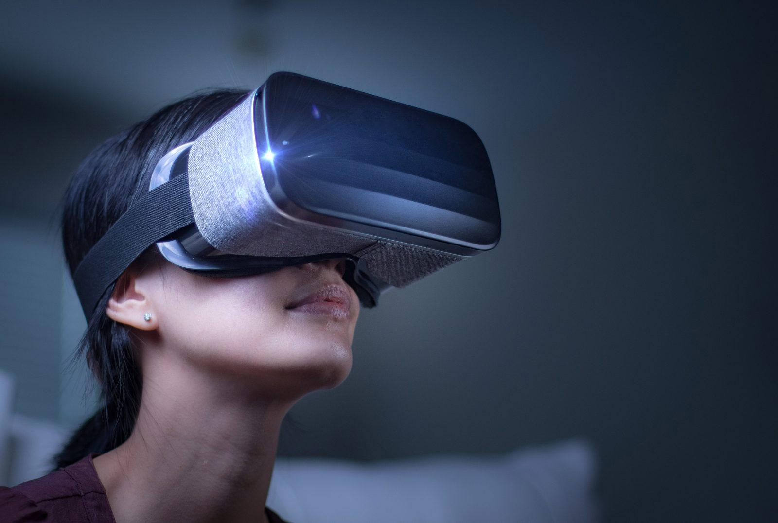 a person wearing a virtual reality headset looks up.