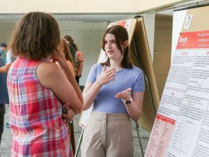 Brock University student Kristen Rose presents a poster of her research on “Predicting Professional Hockey Outcomes Using Regularized Linear Regression.”