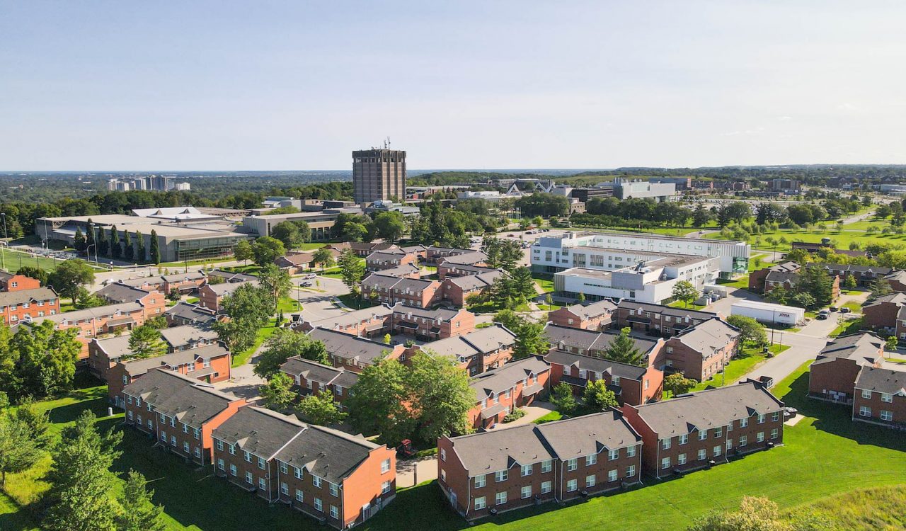 An aerial view of Brock University's main campus surrounded by greenery.