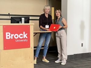 Brock University Faculty of Mathematics and Science Associate Dean Cheryl McCormick presents Madison Bell, PhD in Health Sciences candidate, with a second-place award.