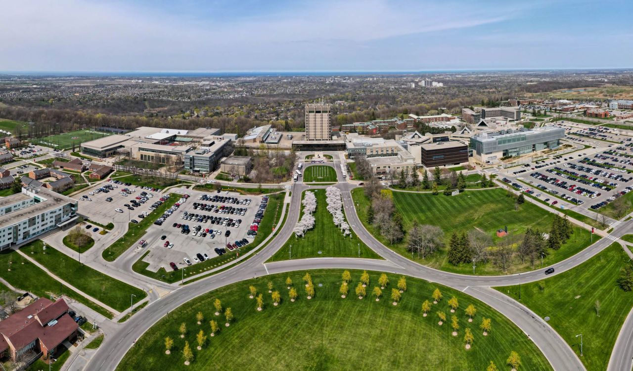 An aerial view of Brock University’s main campus with a traffic circle in the centre.