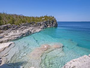 Cliffs overlook clear water in a cove in Bruce Peninsula National Park in Ontario.