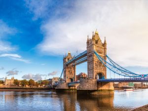 Panoramic London skyline with Tower Bridge and the Tower of London as viewed from South Bank of the River Thames in the morning light.